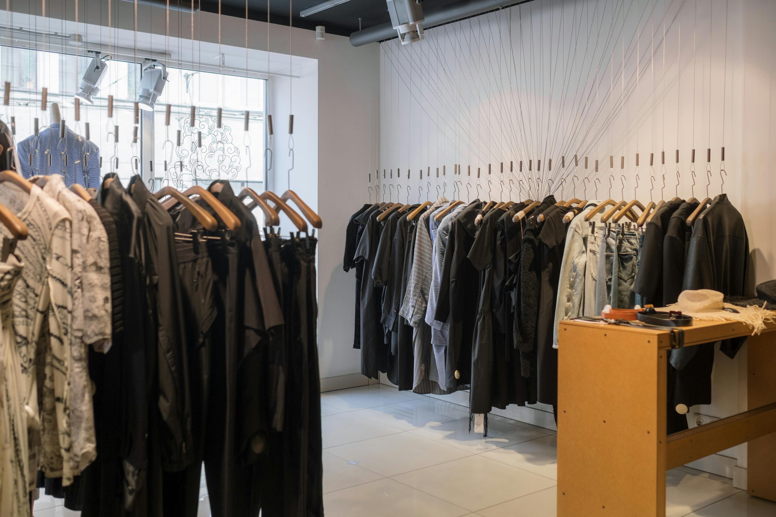 Modern clothing store showcasing a variety of garments on hangers.